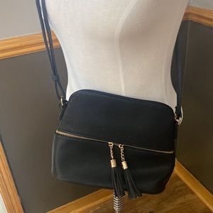 Black & gold crossbody purse with black tassels